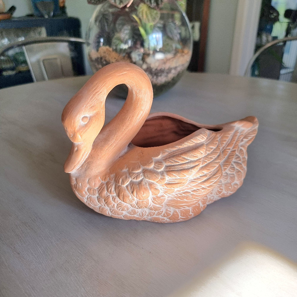 Vintage ceramic swan planter with blush glaze and detailed feather texture, styled on a tabletop.