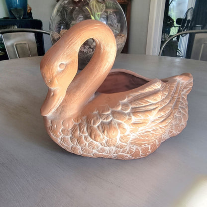 Vintage ceramic swan planter with blush glaze and detailed feather texture, styled on a tabletop.