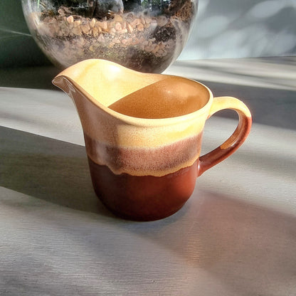 Vintage Crown Lynn cream jug marked 6068 with layered earthy terracotta and caramel glaze.