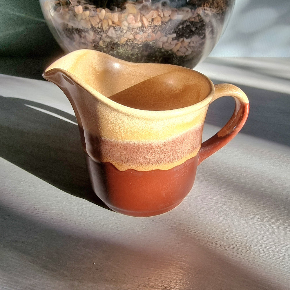Vintage Crown Lynn cream jug marked 6068 with layered earthy terracotta and caramel glaze.