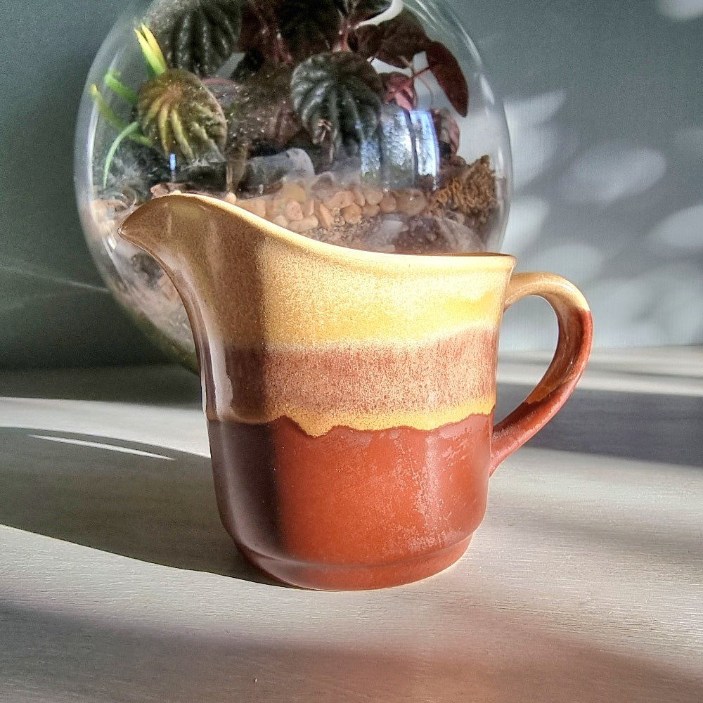 Vintage Crown Lynn cream jug marked 6068 with layered earthy terracotta and caramel glaze.