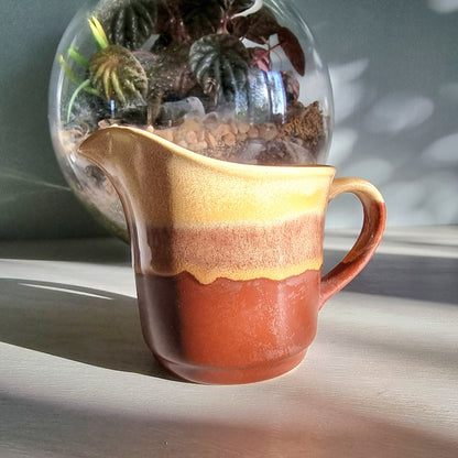 Vintage Crown Lynn cream jug marked 6068 with layered earthy terracotta and caramel glaze.