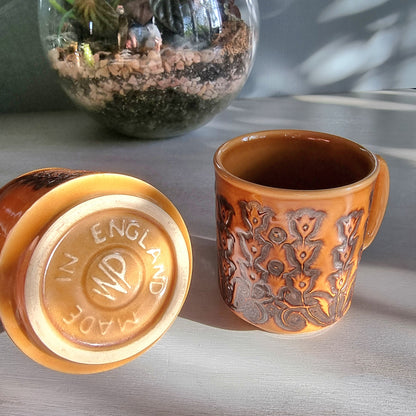 Pair of vintage Winchcombe Pottery floral mugs in honey-brown glaze with embossed design, made in England.