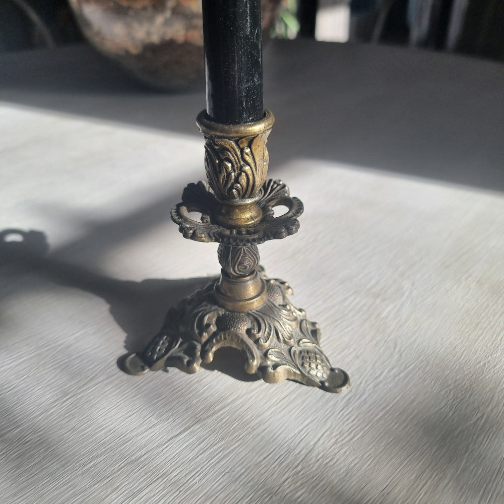 Ornate brass candlestick with detailed tri-foot base stamped Made in Italy.