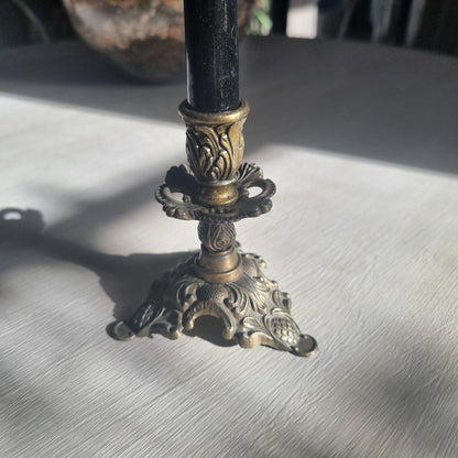 Ornate brass candlestick with detailed tri-foot base stamped Made in Italy.