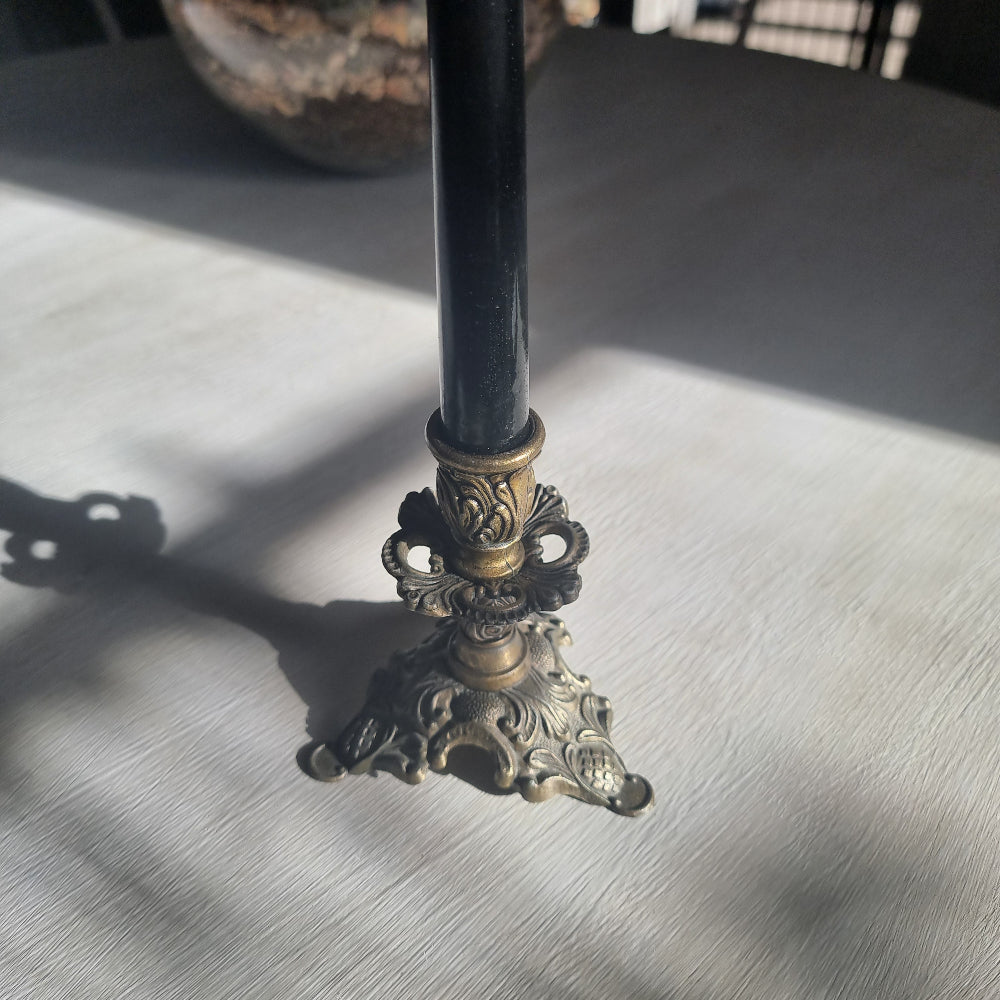 Ornate brass candlestick with detailed tri-foot base stamped Made in Italy.