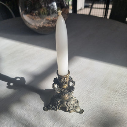 Ornate brass candlestick with detailed tri-foot base stamped Made in Italy.