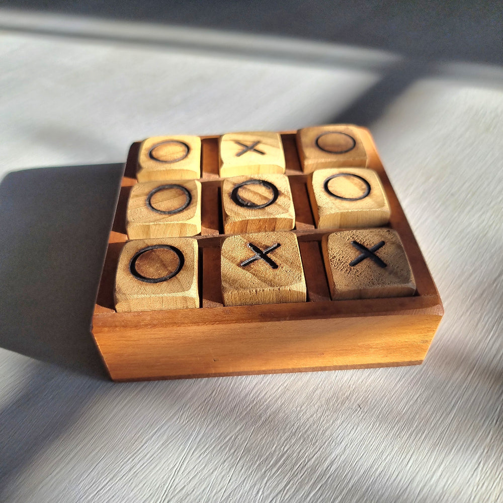 Handmade wooden tic tac toe board with removable X and O wooden playing pieces.