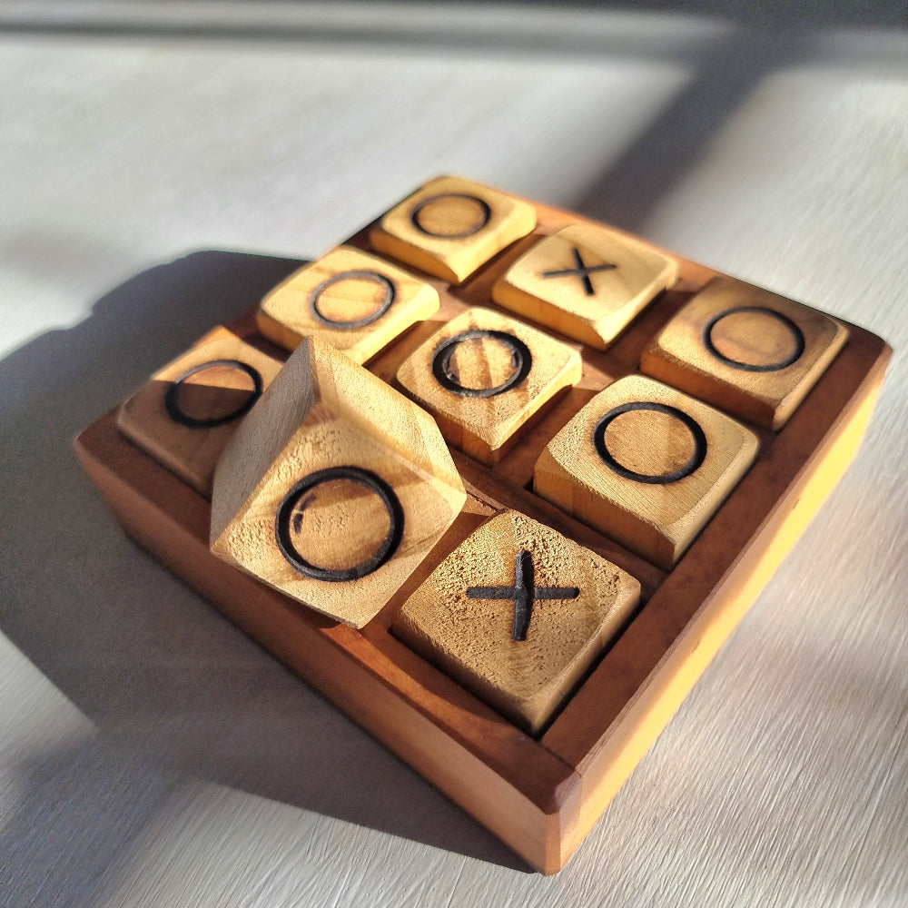 Handmade wooden tic tac toe board with removable X and O wooden playing pieces.