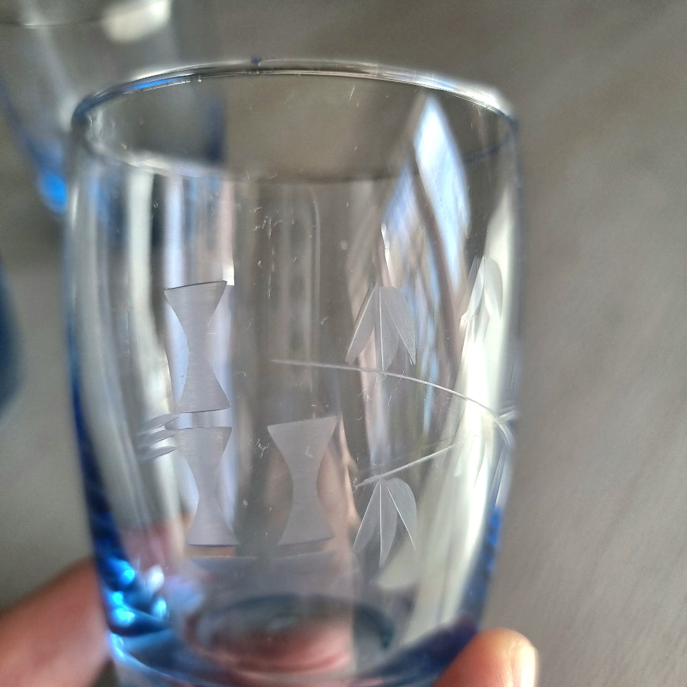 Set of three clear tumblers with blue base and bamboo etched pattern