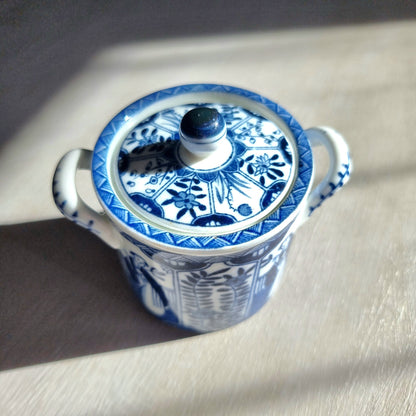 Vintage blue and white twin-handled lidded jar with chinoiserie transferware pattern