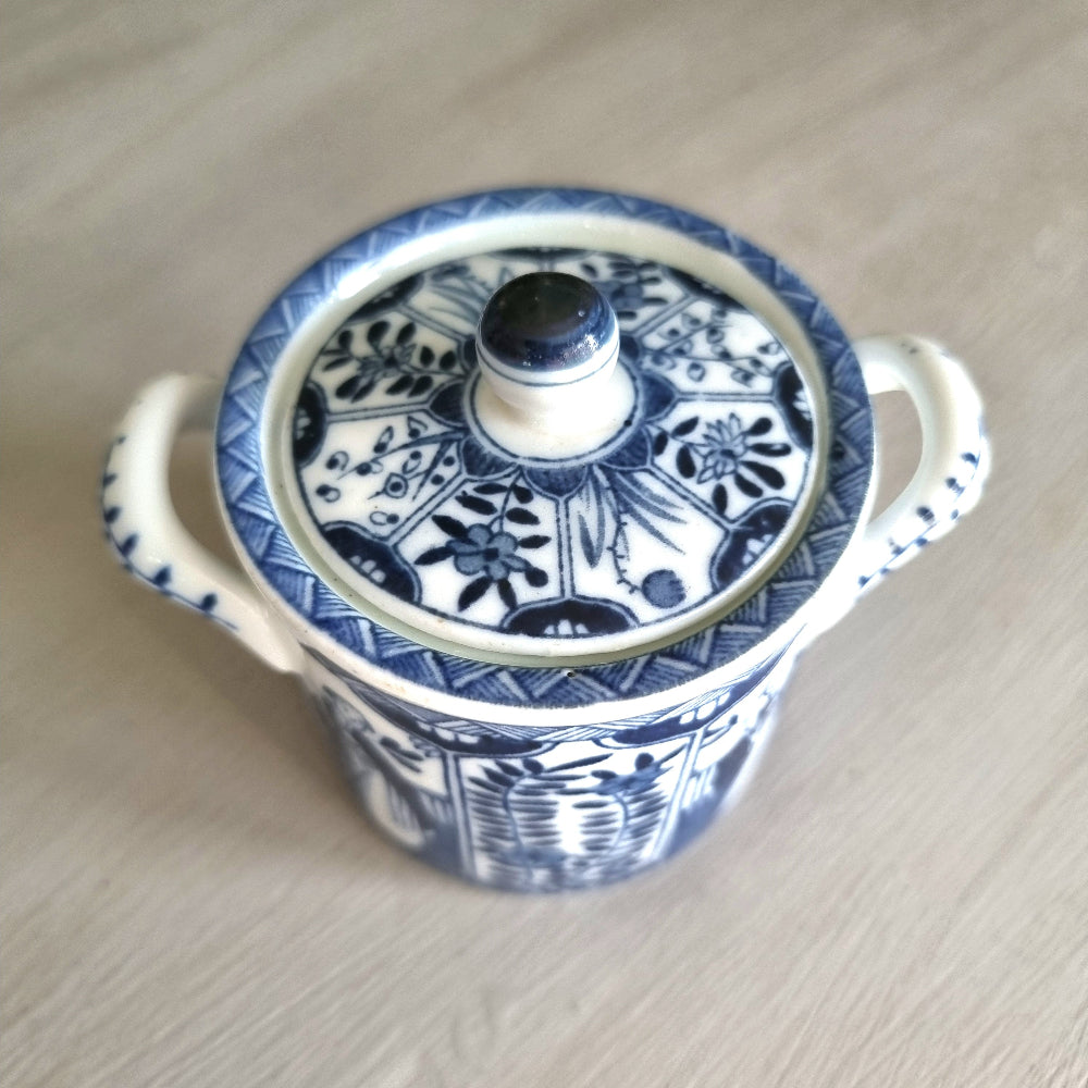 Vintage blue and white twin-handled lidded jar with chinoiserie transferware pattern