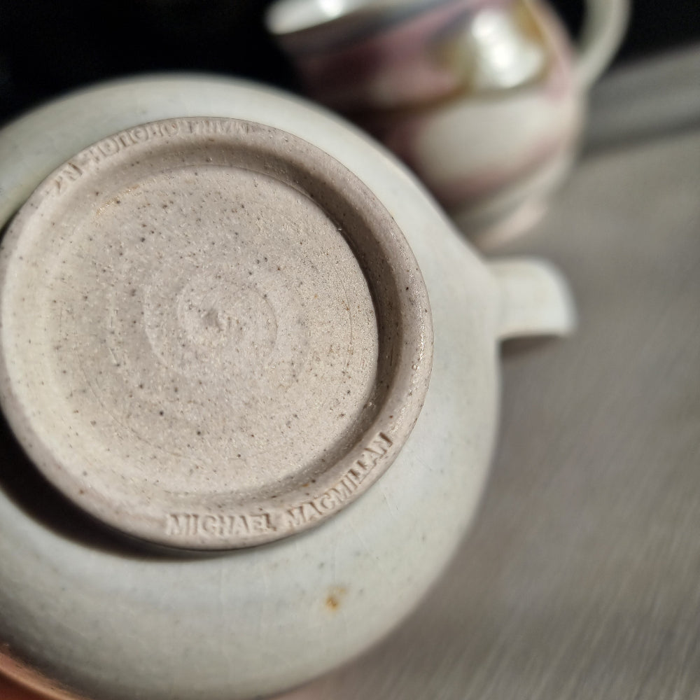 Pair of Michael Macmillan stoneware cups with blush pink, cream and gold swirl glaze