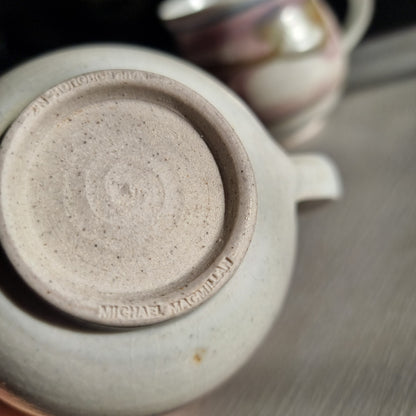 Pair of Michael Macmillan stoneware cups with blush pink, cream and gold swirl glaze