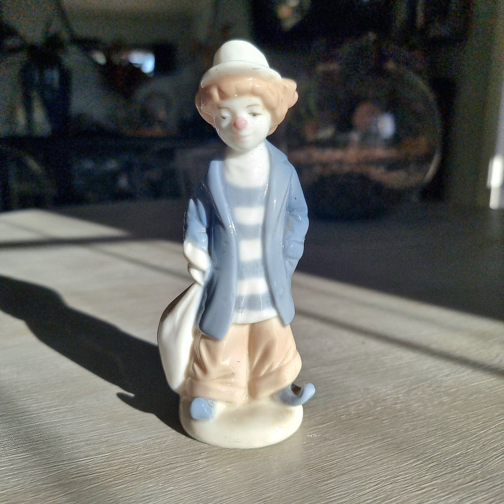  Lladró-inspired porcelain clown figurine in pale blue jacket, striped shirt and white hat