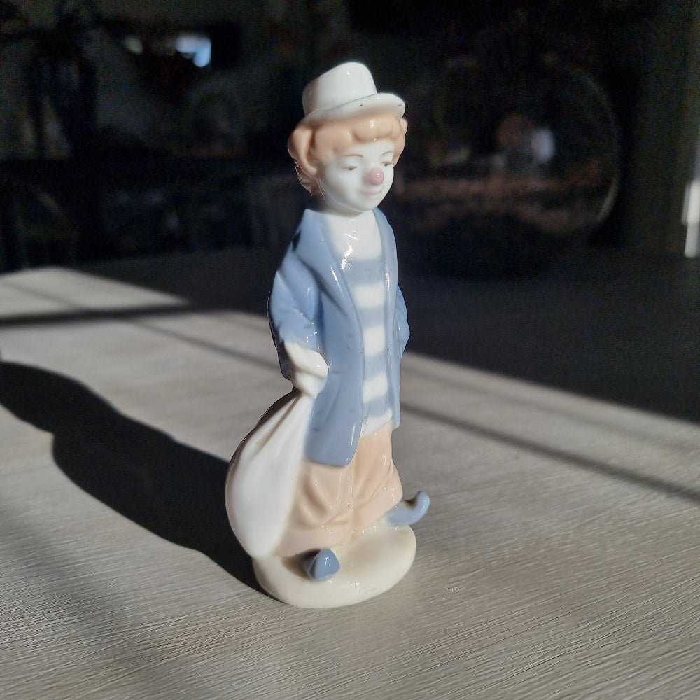  Lladró-inspired porcelain clown figurine in pale blue jacket, striped shirt and white hat