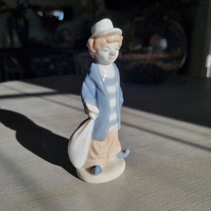  Lladró-inspired porcelain clown figurine in pale blue jacket, striped shirt and white hat