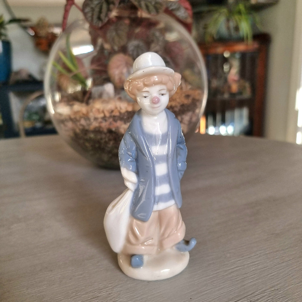  Lladró-inspired porcelain clown figurine in pale blue jacket, striped shirt and white hat