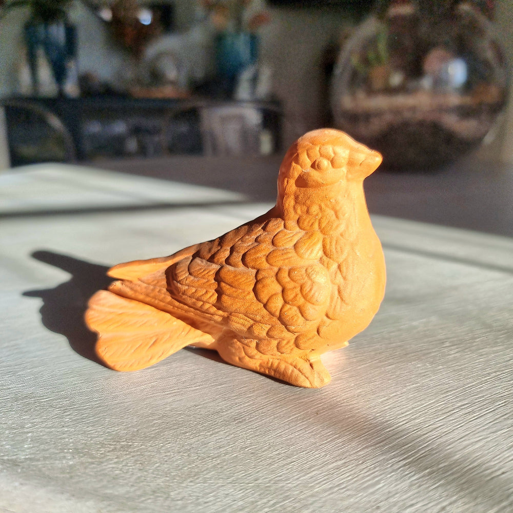 Vintage terracotta bird figurine with all-over floral and feather relief detail