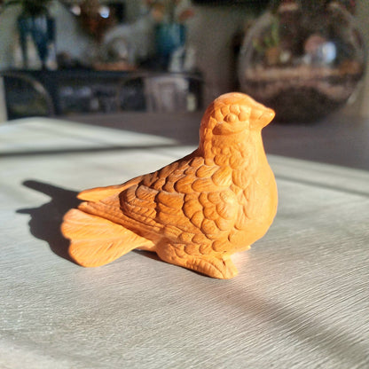 Vintage terracotta bird figurine with all-over floral and feather relief detail