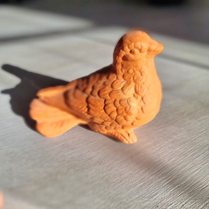 Vintage terracotta bird figurine with all-over floral and feather relief detail