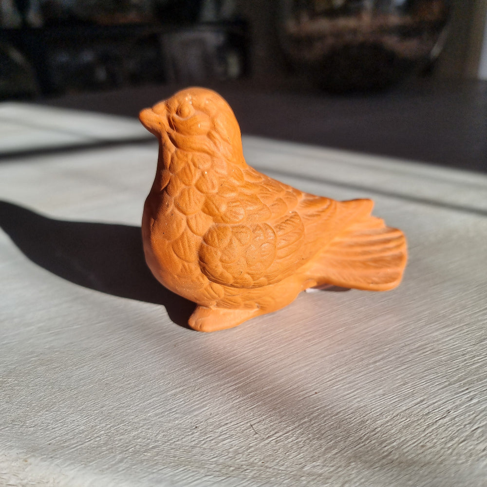 Vintage terracotta bird figurine with all-over floral and feather relief detail