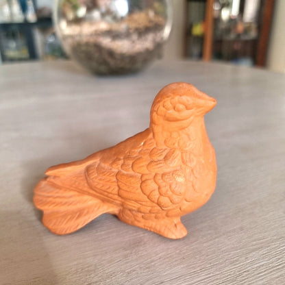 Vintage terracotta bird figurine with all-over floral and feather relief detail
