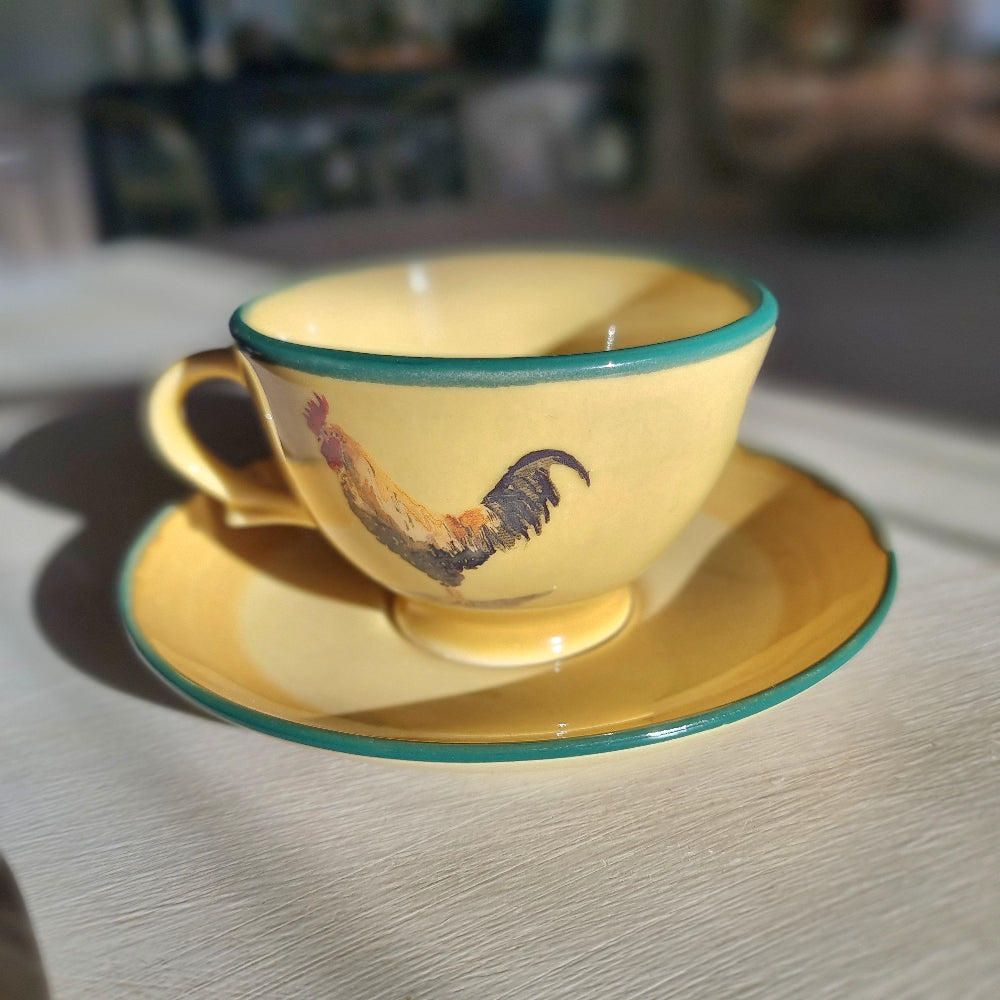 Robert Gordon rooster teacup and saucer with yellow glaze and green rim