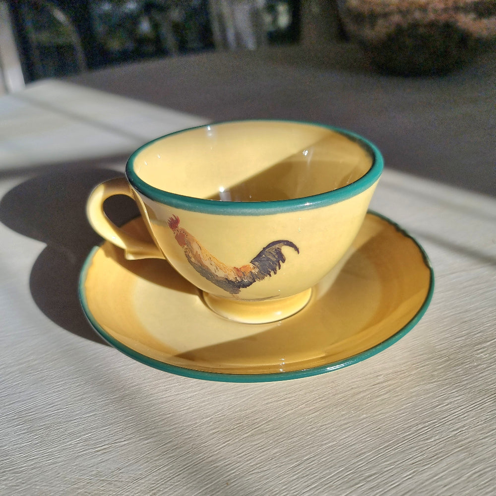 Robert Gordon rooster teacup and saucer with yellow glaze and green rim
