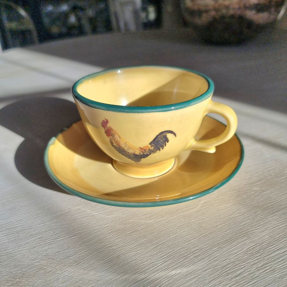 Robert Gordon rooster teacup and saucer with yellow glaze and green rim