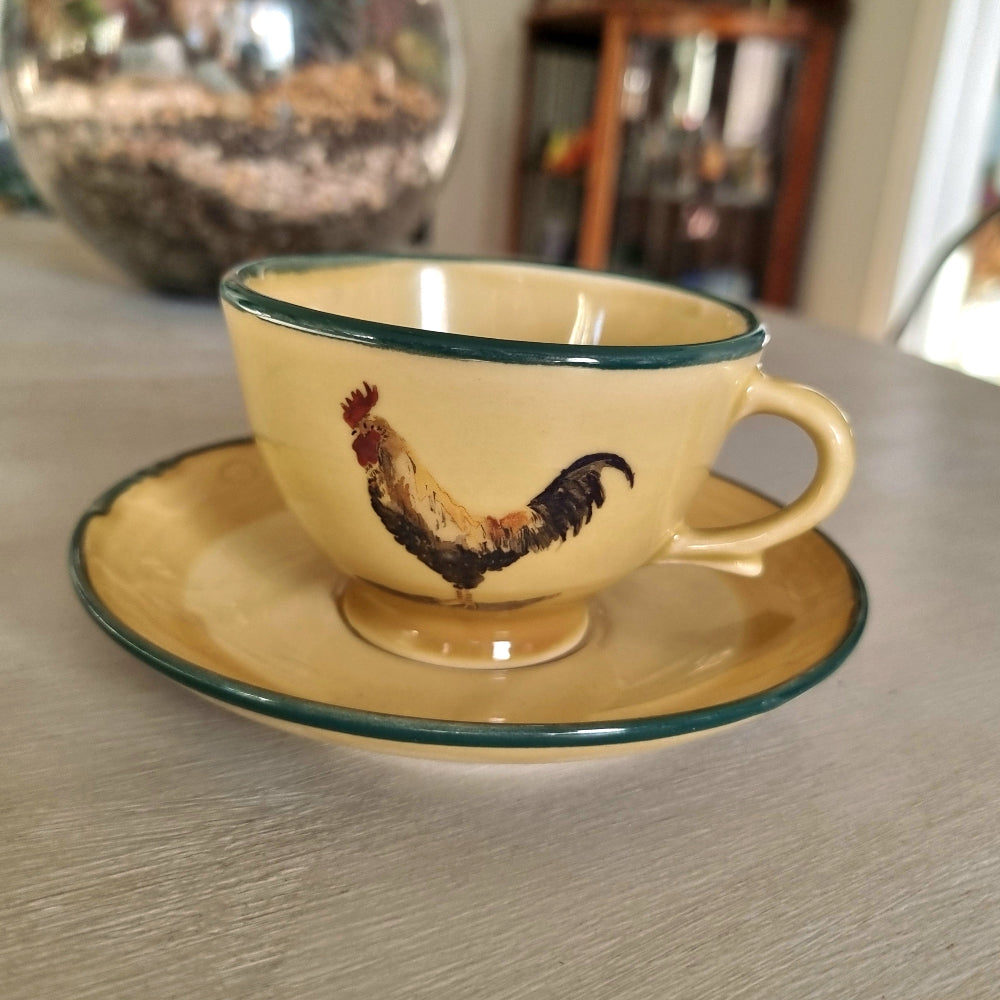 Robert Gordon rooster teacup and saucer with yellow glaze and green rim