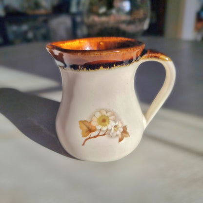 Kermiko pottery cream jug with cream body, rich brown drip glaze rim