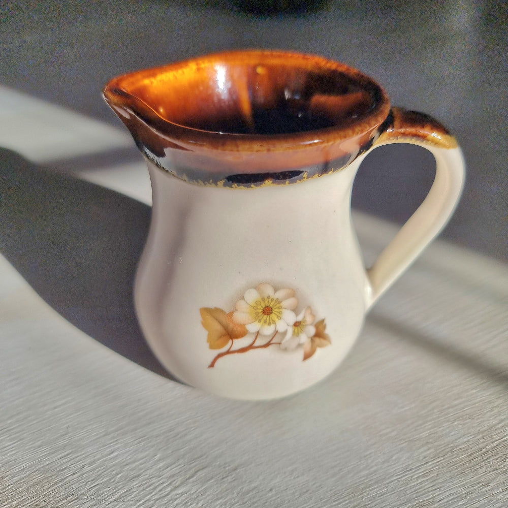 Kermiko pottery cream jug with cream body, rich brown drip glaze rim