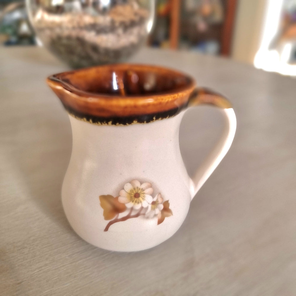 Kermiko pottery cream jug with cream body, rich brown drip glaze rim