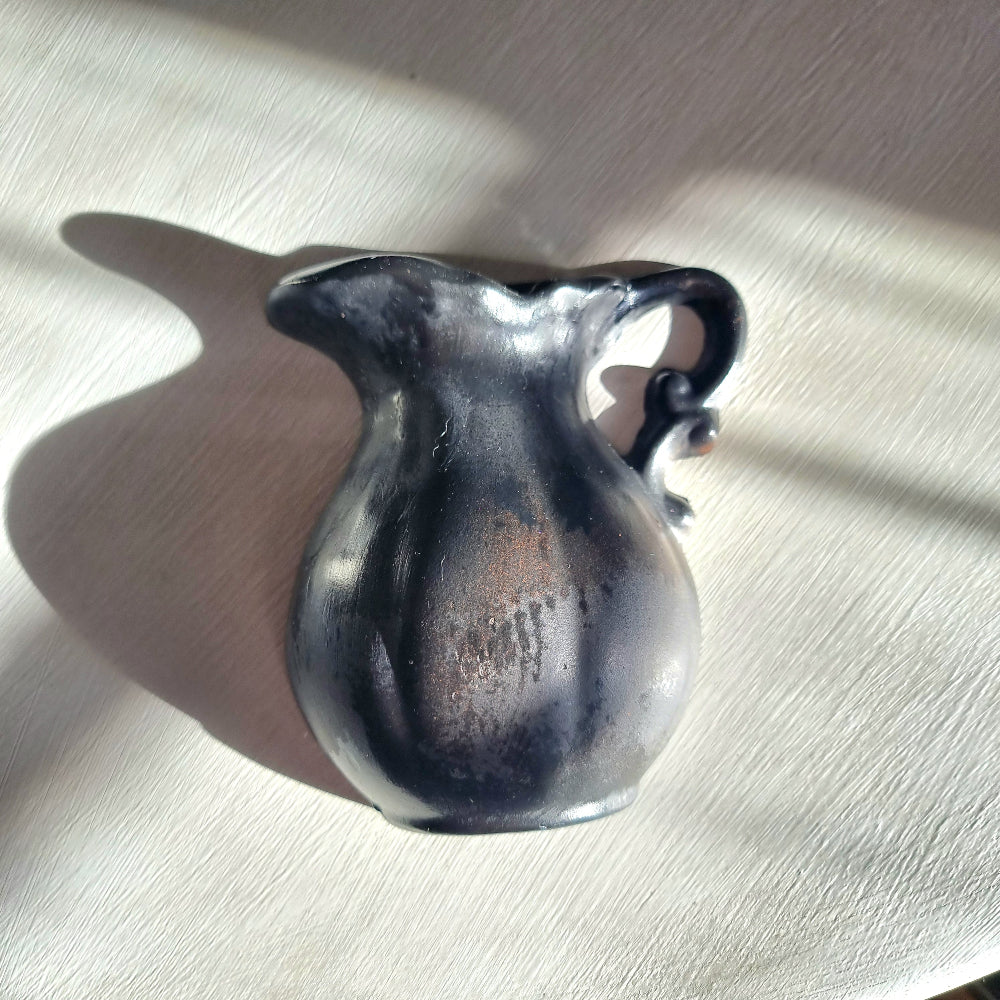 Vintage ceramic wall pocket planter with a dramatic black, bronze and silver lustre glaze