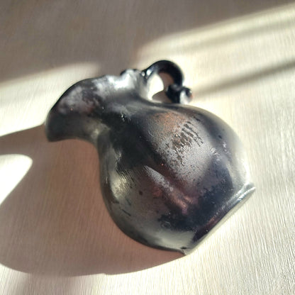 Vintage ceramic wall pocket planter with a dramatic black, bronze and silver lustre glaze