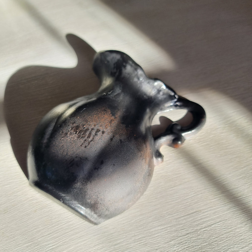 Vintage ceramic wall pocket planter with a dramatic black, bronze and silver lustre glaze