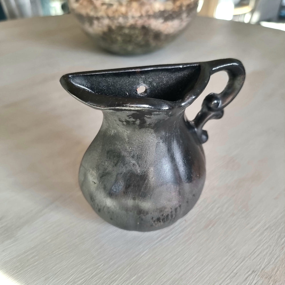 Vintage ceramic wall pocket planter with a dramatic black, bronze and silver lustre glaze
