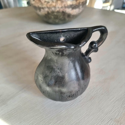 Vintage ceramic wall pocket planter with a dramatic black, bronze and silver lustre glaze
