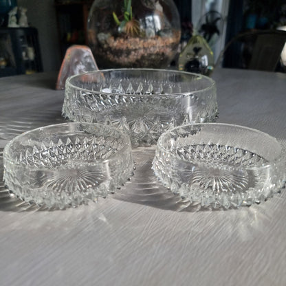 Pressed glass diamond point bowl set with one large and two small bowls, sparkling in natural light