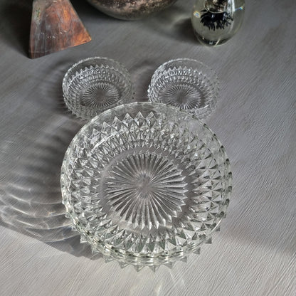 Pressed glass diamond point bowl set with one large and two small bowls, sparkling in natural light