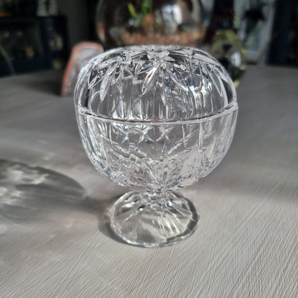 Cut crystal lidded trinket dish on pedestal with starburst pattern and faceted design