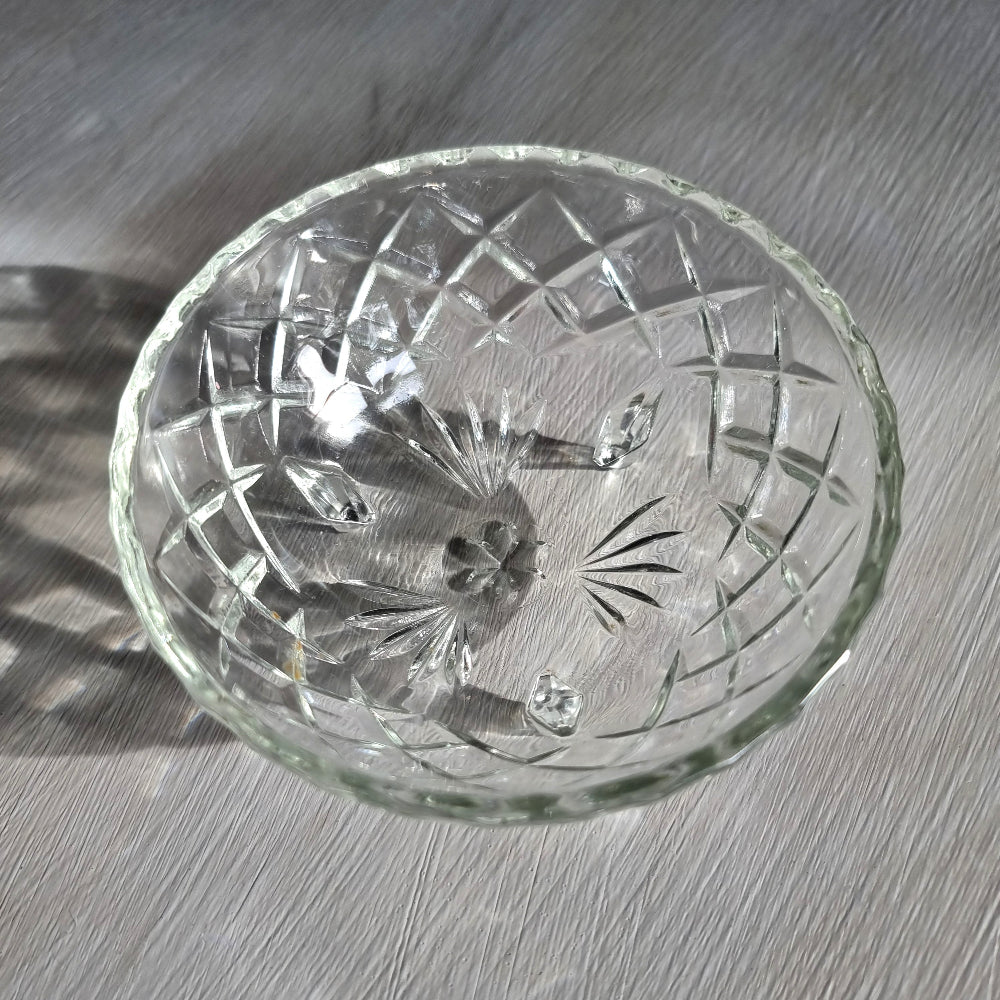 Cut glass trinket bowl with starburst and diamond pattern on three small feet