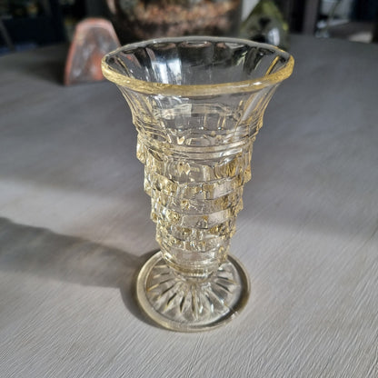 Art deco pressed glass vase with stepped geometric pattern and flared top