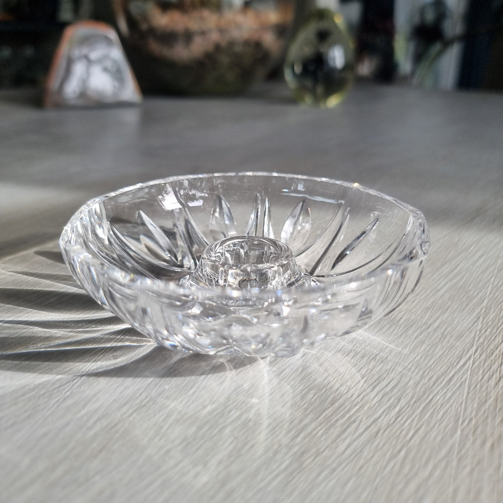 Vintage cut crystal candle holder with starburst pattern, overhead view showing sunburst cut detail