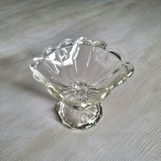 Vintage pressed glass footed dish with scalloped petal rim and ribbed bowl panels