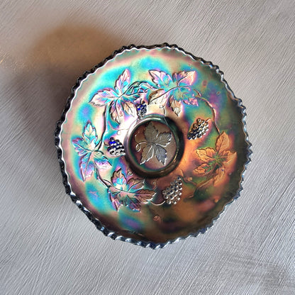Vintage Fenton carnival glass berry bowl with iridescent rainbow finish and raised grapevine pattern.