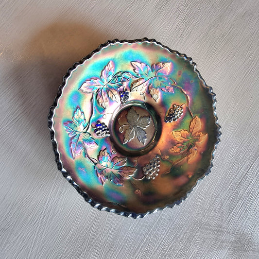 Vintage Fenton carnival glass berry bowl with iridescent rainbow finish and raised grapevine pattern.