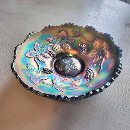 Vintage Fenton carnival glass berry bowl with iridescent rainbow finish and raised grapevine pattern.