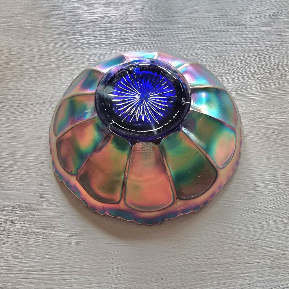 Vintage Fenton carnival glass berry bowl with iridescent rainbow finish and raised grapevine pattern.